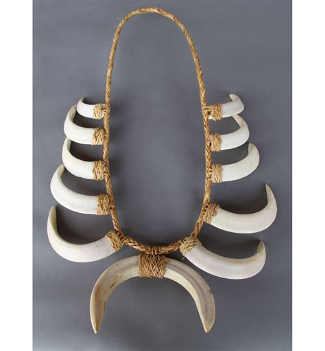 Rattan basketry weave is designed on each of the <strong>tusks</strong>. . Boar tusk necklace meaning
